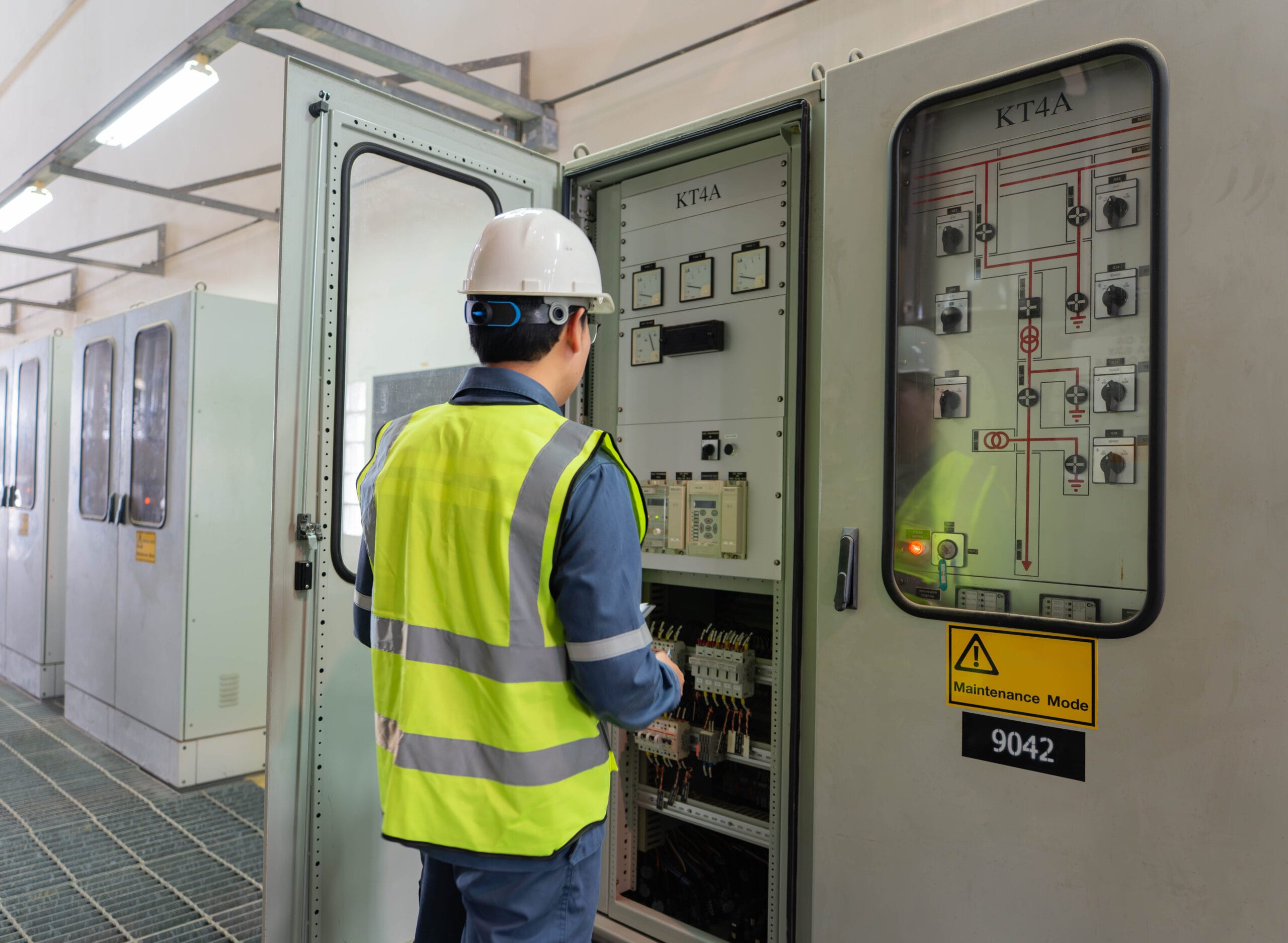 Engineer performing electrical panel inspection in a substation control room, working in maintenance mode to verify wiring, relays, and monitoring systems for safe and reliable power operation. Plumbers Winnipeg